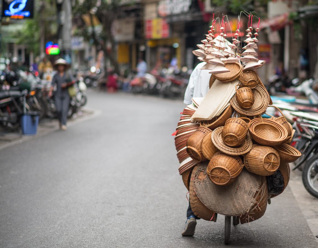 Cyclist carrying lots of baskets, old quarter, Hanoi