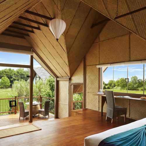 Interior view of Paddy Dwelling bedroom and balcony. Jetwing Vil Uyana