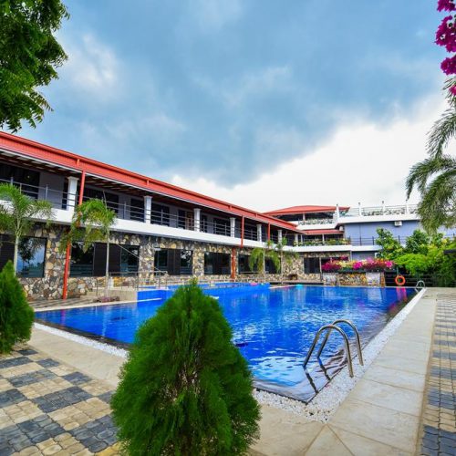 View of Centauria Wild's outdoor pool and rooms behind